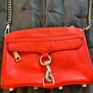 Rebecca Minkoff mini Mac bag in a bright reddish orange.